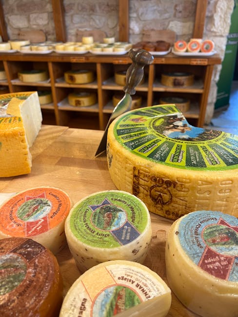 Ronde kazen met kleurrijke etiketten op houten tafel in Piemonte kaasshop