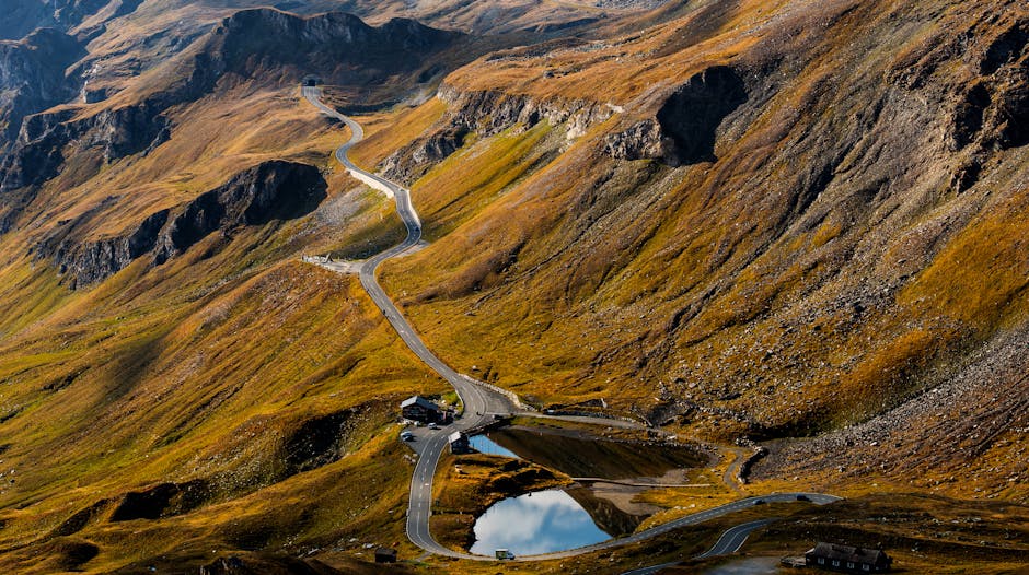Winding high mountain road snaking past reflective pools in Piedmont
