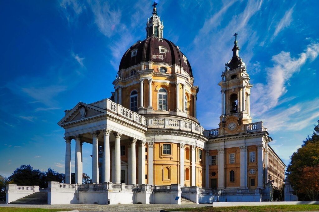 Grand domed Superga Basilica with tall columns against blue sky, Piedmont