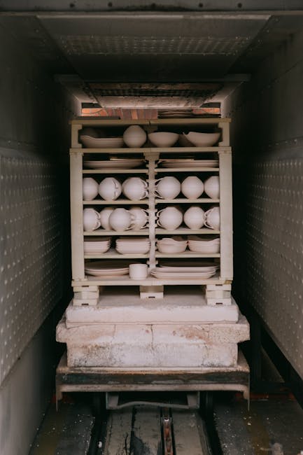 Shelved bisque ceramics loaded inside a kiln awaiting firing in Latium