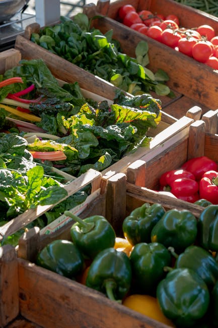 Wooden crates of peppers, tomatoes and greens at Latium market