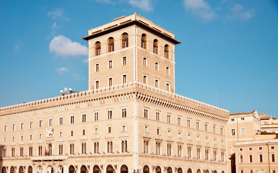 Sunlit historic palazzo in Latium with tall tower and blue sky