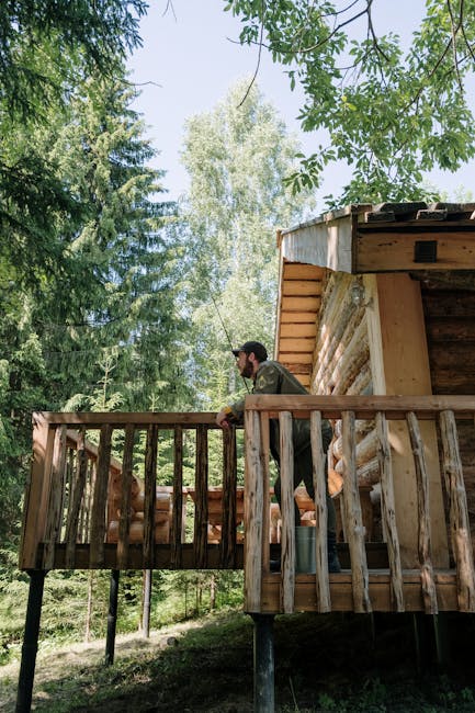 Man leaning on wooden cabin balcony surrounded by pine trees in Latium