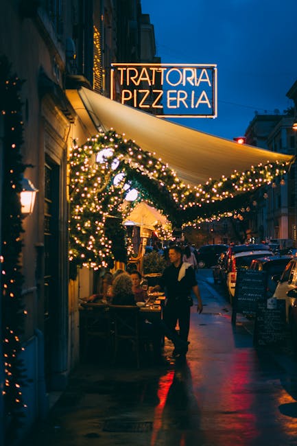 Outdoor trattoria with illuminated 'Trattoria Pizzeria' sign in Rome, Latium