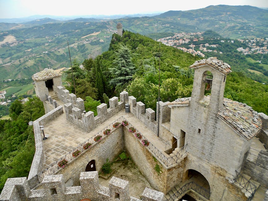 Stone crenelated terrace and small bell tower above Latium valleys.