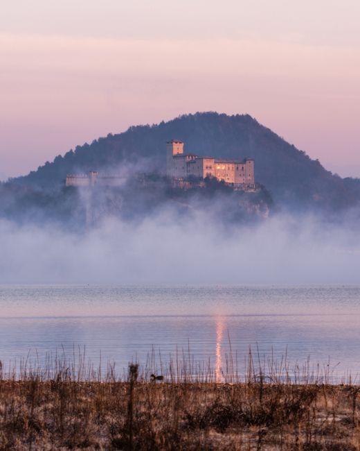 Zamek nad jeziorem Bracciano w Lacjum otoczony poranną mgłą