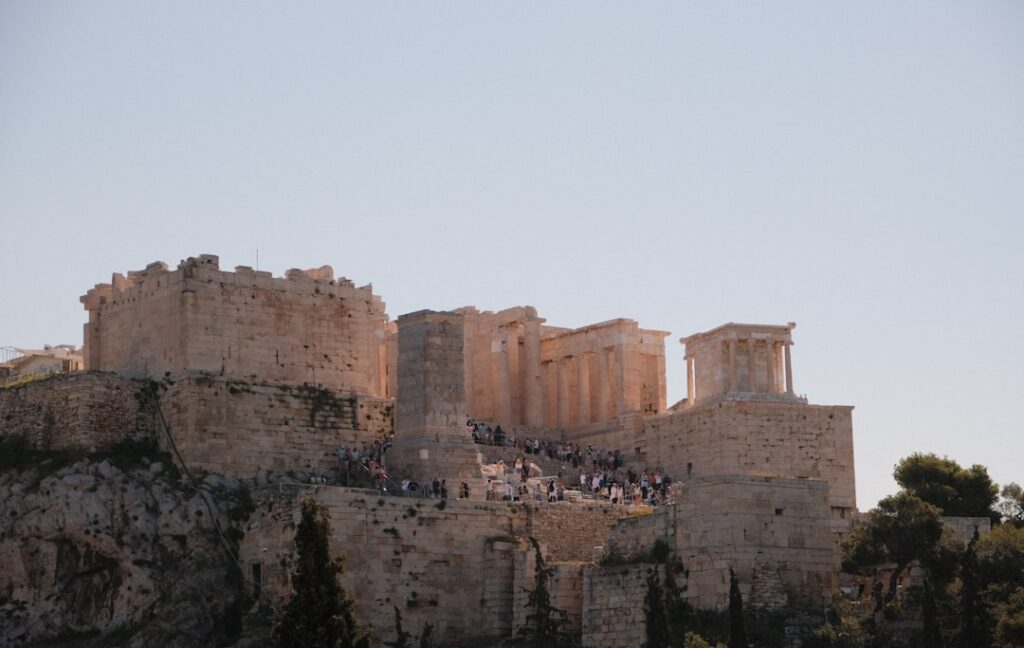 Exterior of the Acropolis Museum at dusk, lit up against the evening sky
