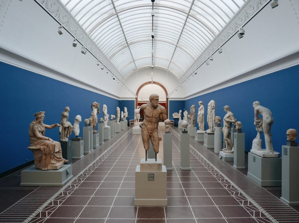 Interior view of the National Archaeological Museum showing large Greek statues