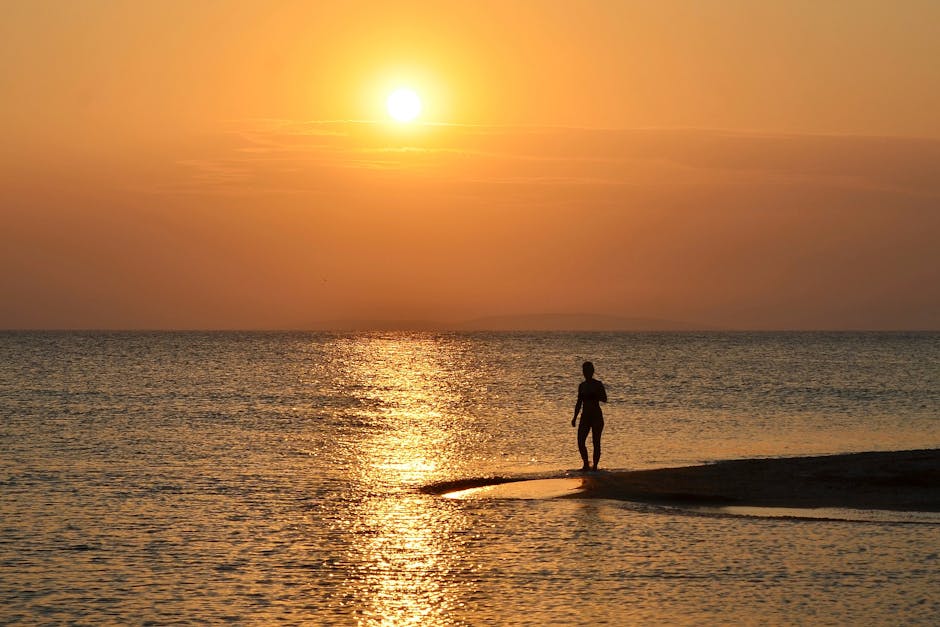 Zonsondergang bij Kreta met silhouet van wandelaar op zandbank