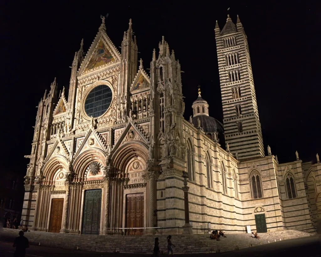 Der beleuchtete Dom von Siena nachts vor dunklem Himmel