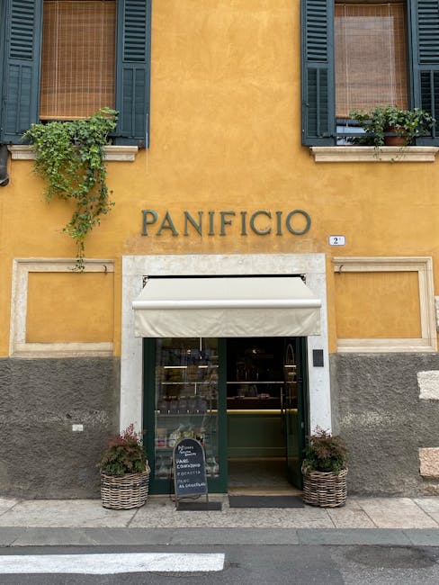 Yellow building with 'PANIFICIO' bakery storefront in Siena street