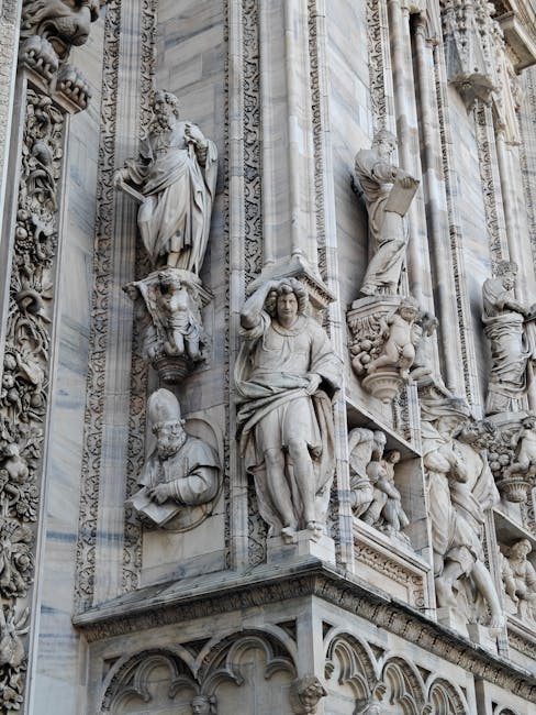 Detailed marble statues and ornate carvings on a cathedral façade in Siena
