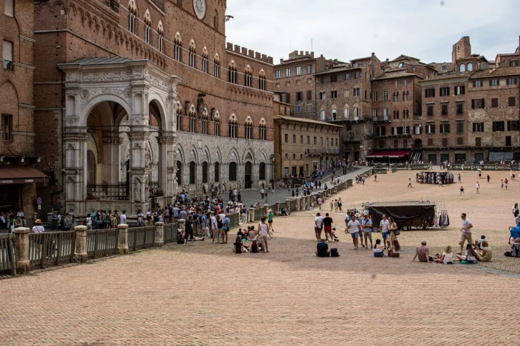 La Piazza del Campo à Sienne, foule et arcades du Palazzo Pubblico