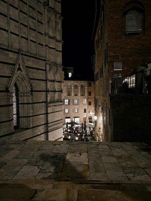 Old street in Siena with evening lights