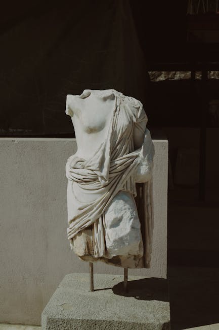 Weathered marble torso of a draped female statue exhibited at Rhodes