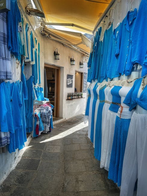 Allée étroite bordée de robes bleues suspendues, boutique à Rhodes