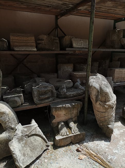 Weathered stone statue fragments and architectural blocks stored in Rhodes