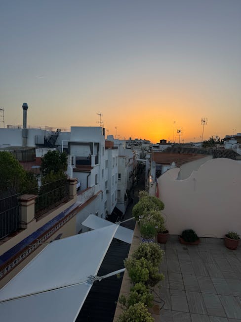 Rooftop terrace overlooking narrow Rhodes street at golden sunset