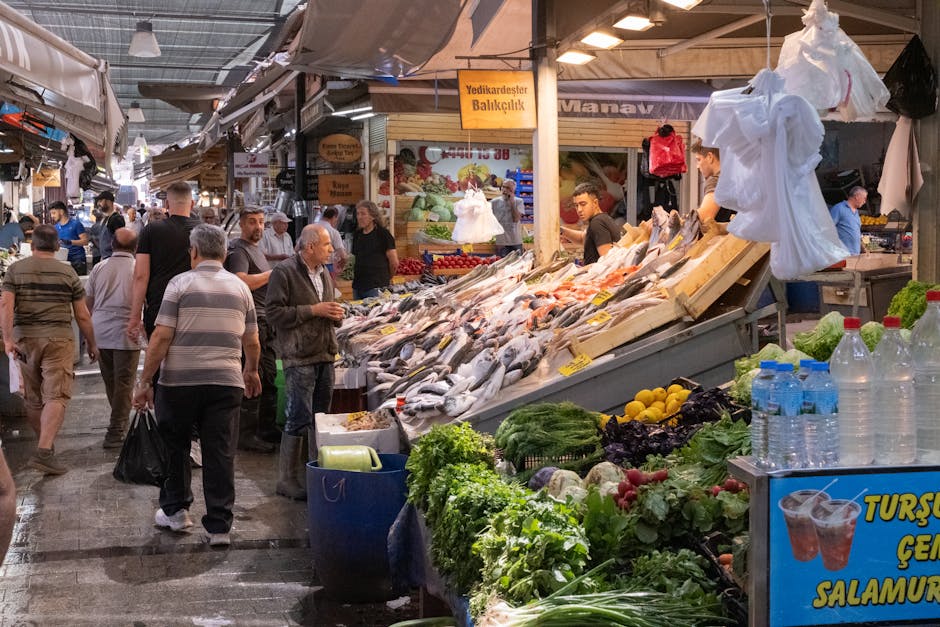 Busy Rhodes market aisle showing fresh fish stalls and shoppers