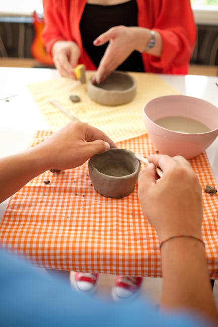 Hands shaping a small clay bowl during a Rhodes ceramics workshop