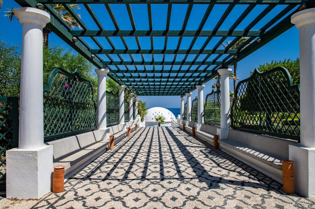 Shaded colonnade with patterned floor and sea view in Rhodes