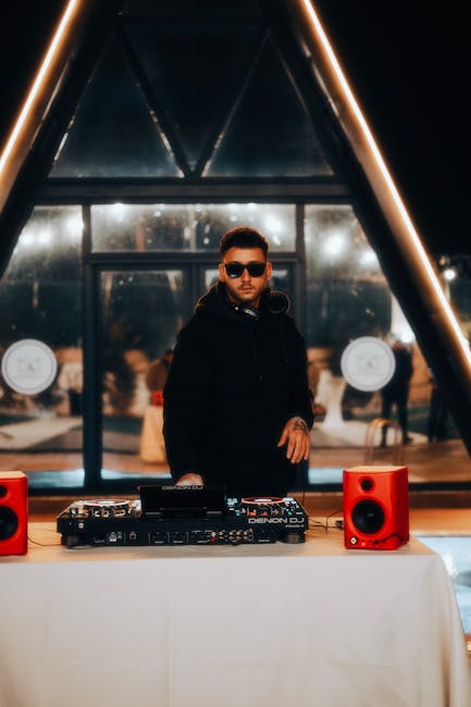 DJ wearing sunglasses at mixer inside intimate Mykonos club at night