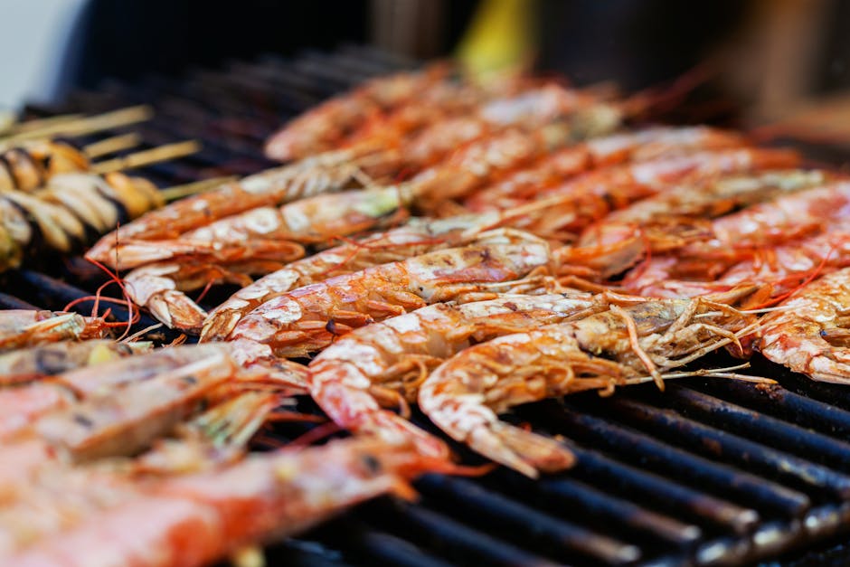 Crevettes grillées alignées sur le barbecue, gros plan appétissant