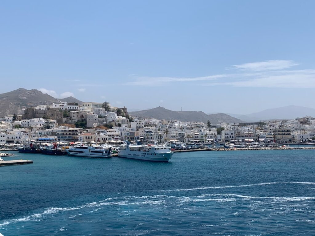 View of Mykonos harbor with blue sea and docked boats