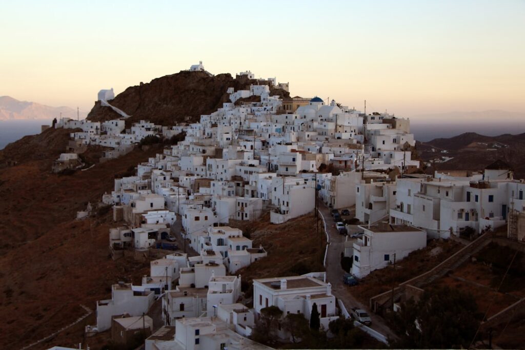 Serifos hilltop white houses clustered under sunset sky