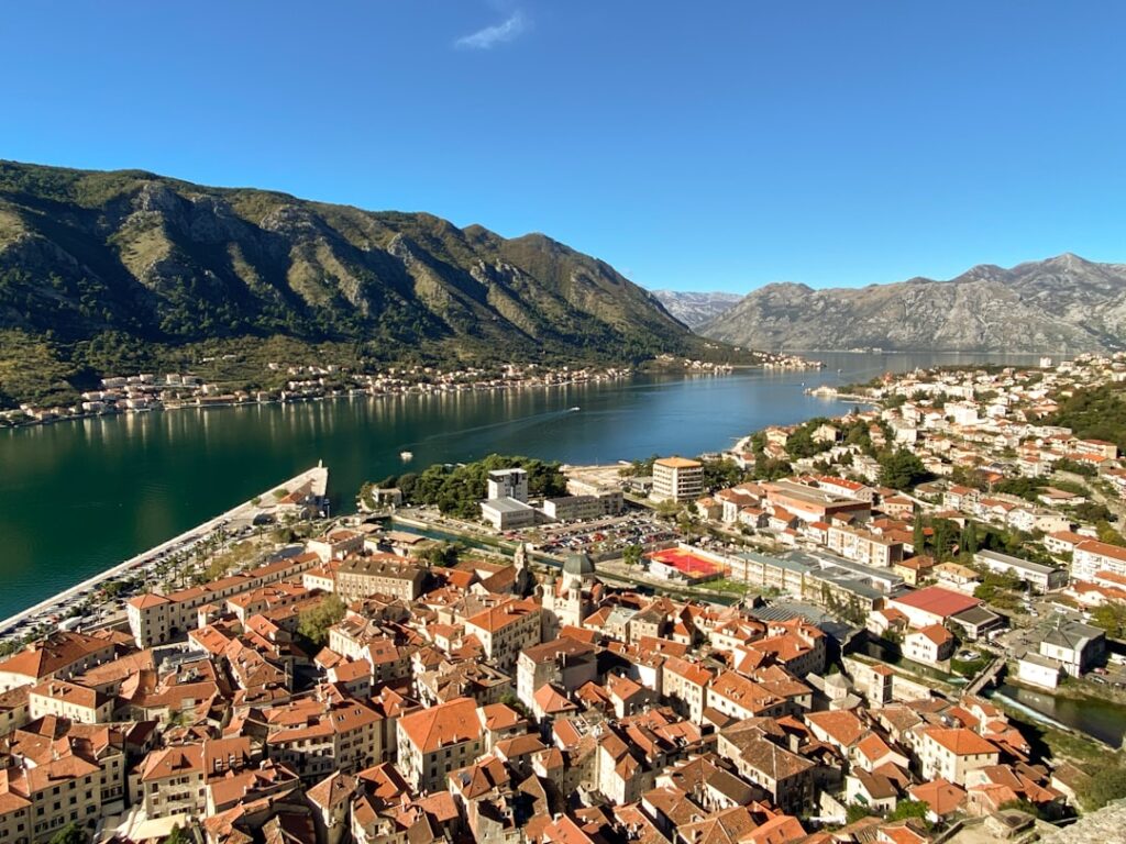 Aerial view of Kotor Old Town with red roofs and shimmering bay
