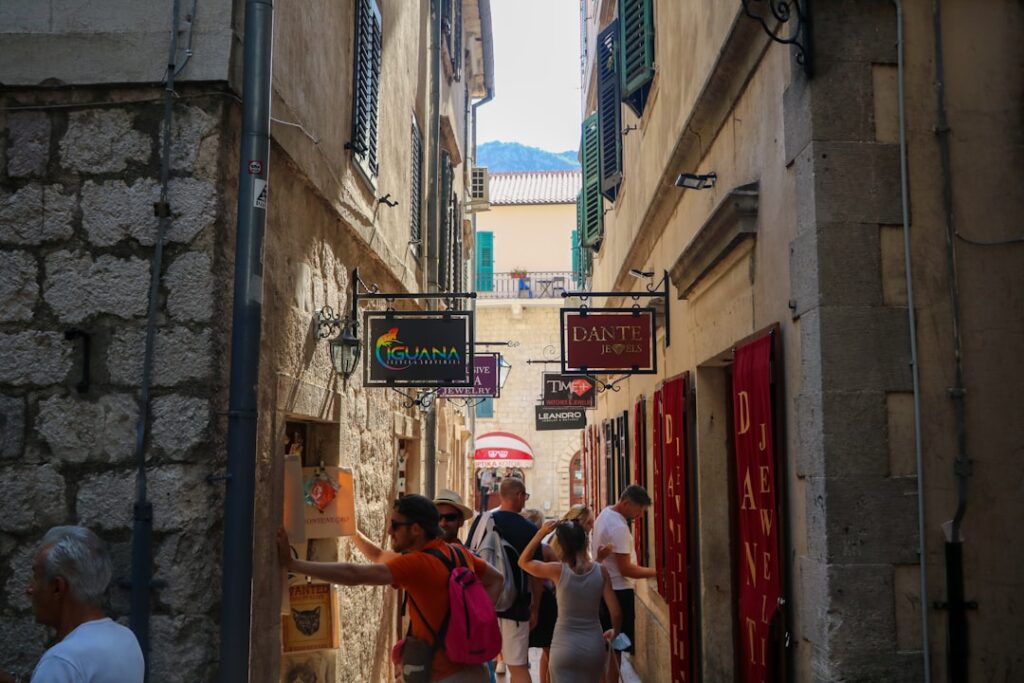 Traveler walking a narrow medieval alley in Kotor old town