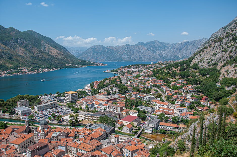 Aerial view of Kotor bay with red-roofed town and mountains