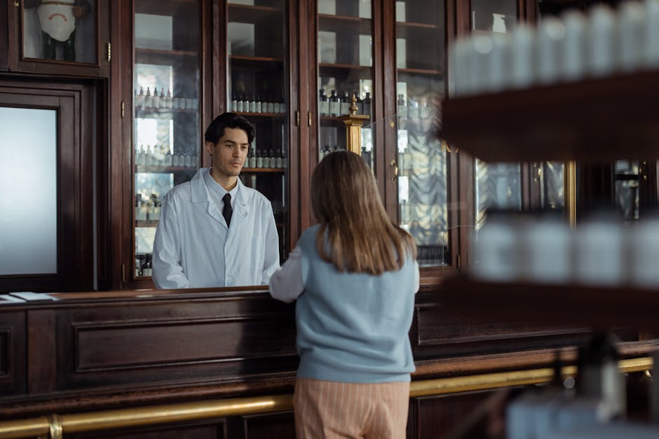 Pharmacist behind wooden counter serving a customer in a pharmacy