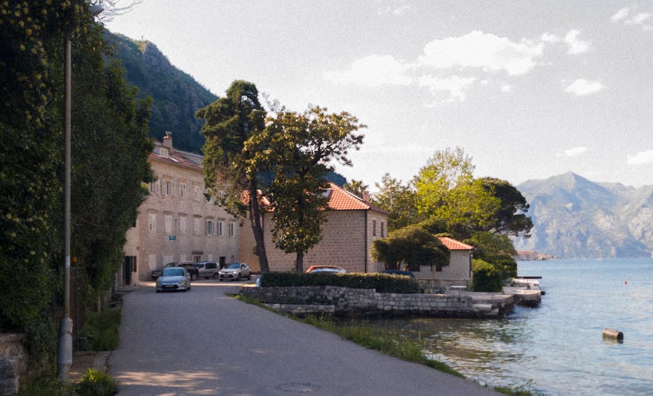 Coastal road beside stone houses and waterfront in Kotor