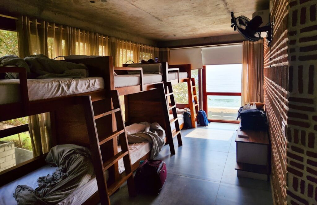 Backpack with travel essentials in a hostel room
