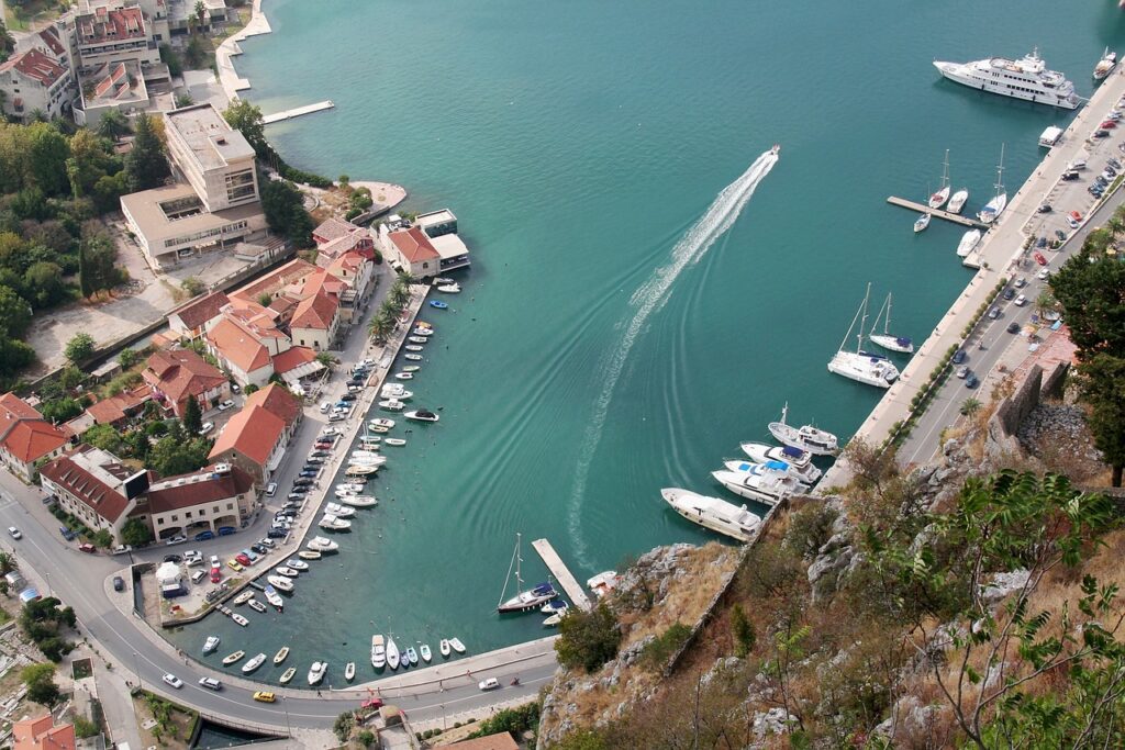 Aerial view of Kotor marina with boats and turquoise bay