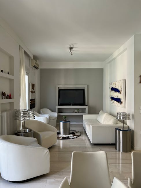 Bright modern living room with white sofas in a Tirana apartment