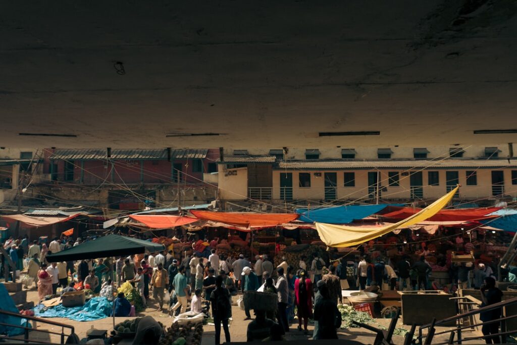 Crowded outdoor market under colorful tarps in central Tirana