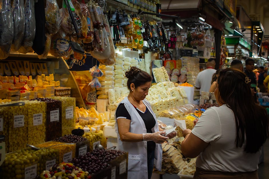 Vendor handing a sample of cheese at Pazari i Ri