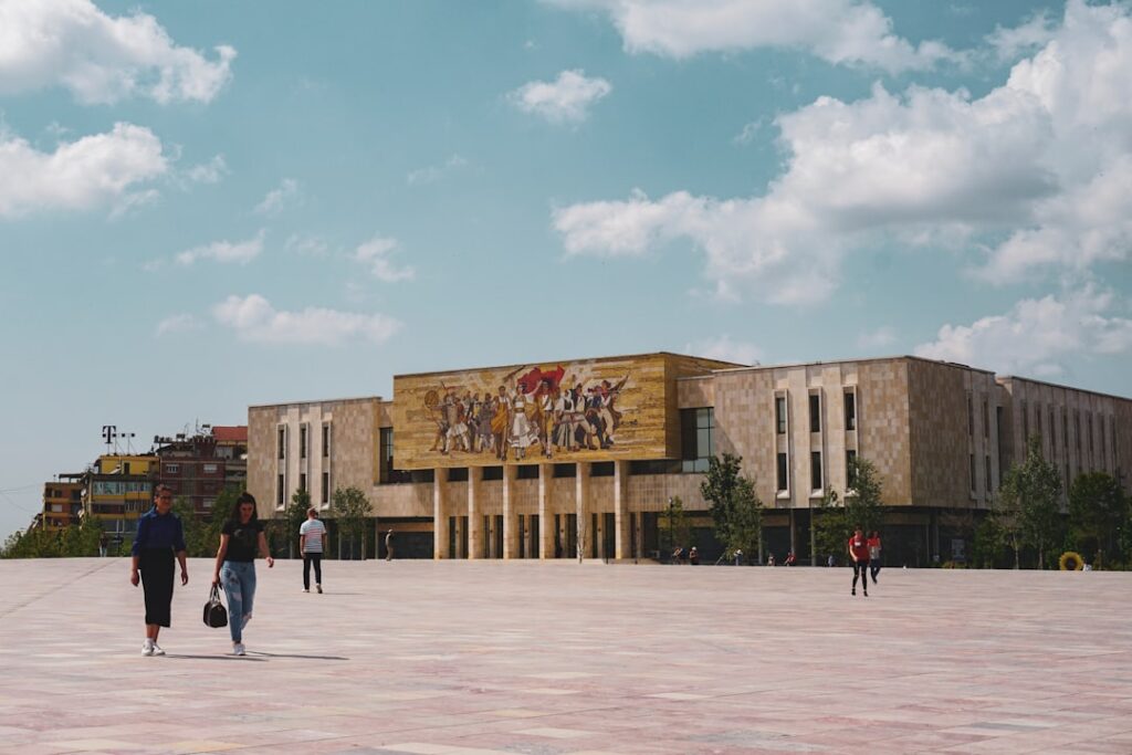 Large mosaic on Tirana's National Historical Museum facade overlooking broad Skanderbeg Square