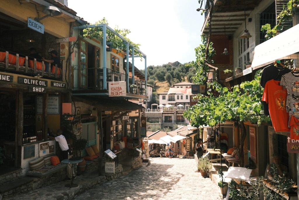 Narrow cobblestone street in old town Kotor with cafes