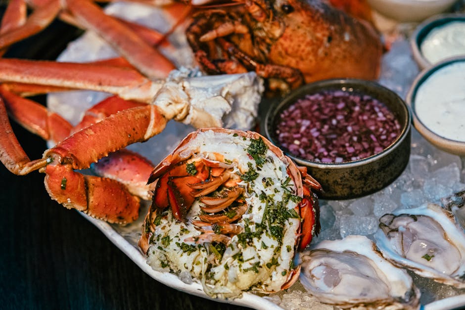 Montenegrin seafood platter with lobster, oysters, and sauces on ice