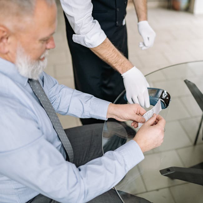 Passenger holding receipt while uniformed attendant in gloves completes payment at Tivat Airport