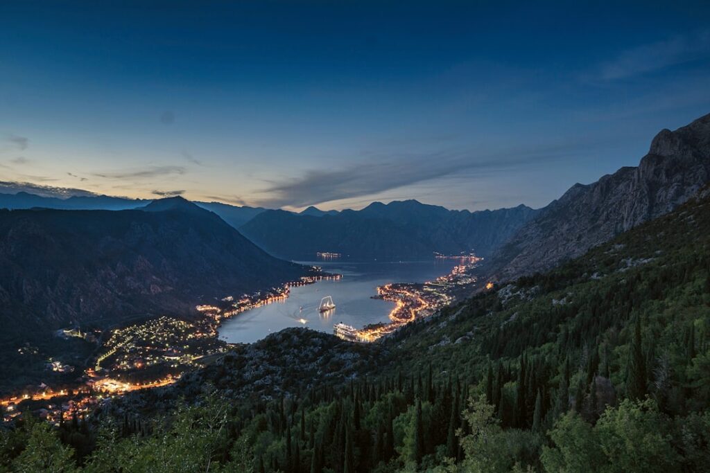 Twilight view of Kotor Bay lights and boat in Montenegro