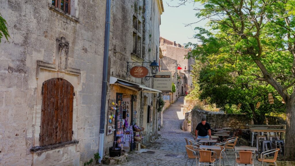 Historic cobbled street with stone shops and outdoor café seating in Montenegro