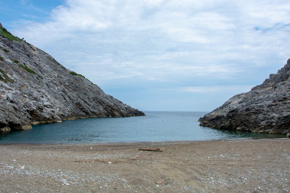 Secluded pebble beach clear turquoise water Grama Bay cove