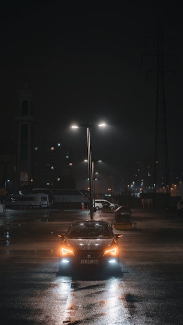 car parked at lighted parking lot at night