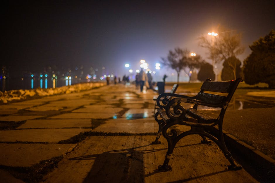 nighttime coastal promenade with lights and people in Albania
