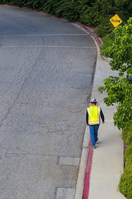 person wearing reflective vest walking along rural road at night
