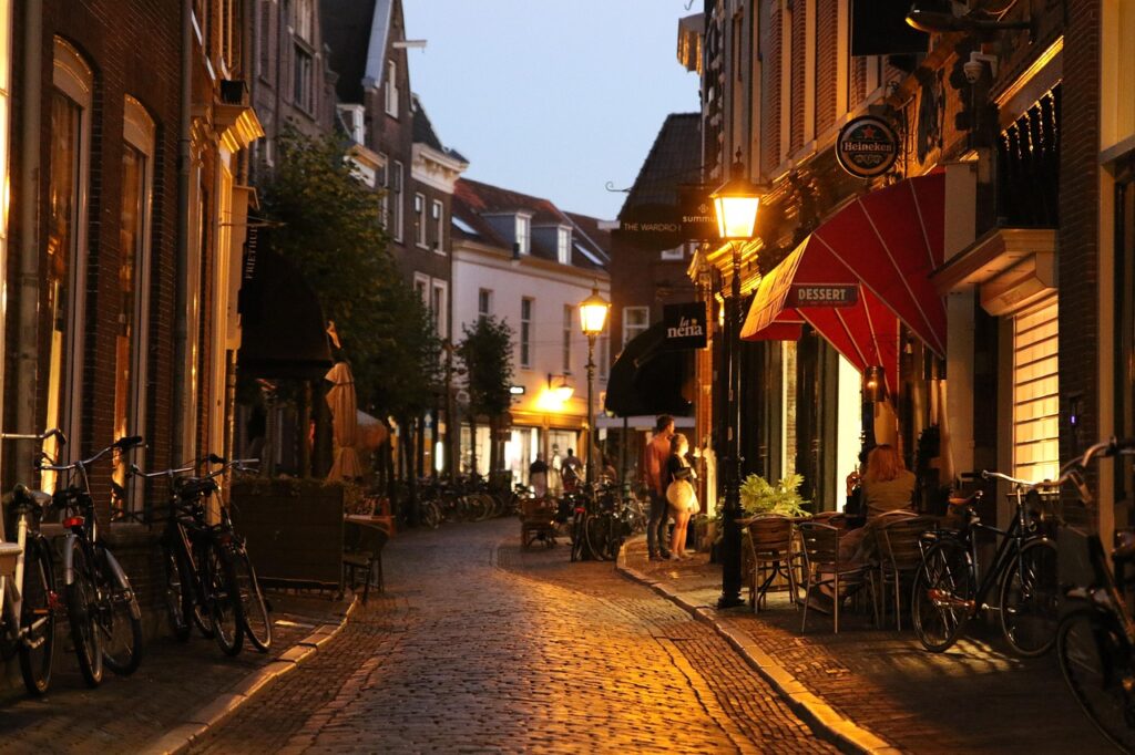 Evening cobblestone street with cafés and bicycles in Albania